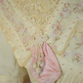 Dress, cream wool trimmed with lace, pink velvet, and multi-colored machine embroidery, 1908, detail of bodice trim