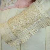 Dress, cream wool trimmed with lace, pink velvet, and multi-colored machine embroidery, 1908, detail of sleeve