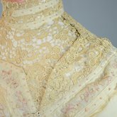 Dress, cream wool trimmed with lace, pink velvet, and multi-colored machine embroidery, 1908, detail of upper bodice closure