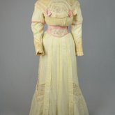 Dress, cream wool trimmed with lace, pink velvet, and multi-colored machine embroidery, 1908, front view