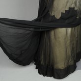 Dress, House of Worth, black silk chiffon and cream silk satin with cream lace, 1910-1915, detail beneath the skirt drape in back