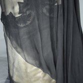 Dress, House of Worth, black silk chiffon and cream silk satin with cream lace, 1910-1915, detail of side of skirt with lace and drape
