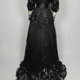 Evening gown, House of Rouff, black silk taffeta and satin with layered black net overlays embroidered with elongated black spangles and round sequins, c. 1905, back view