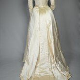 Wedding dress, cream silk satin and lace with long sleeves and a train, c. 1905, back view