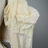 Wedding dress, cream silk satin and lace with long sleeves and a train, c. 1905, detail of padding inside lining