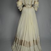 Wedding dress, pale green silk crepe with silver satin, pont d’esprit, and lace, with matching gray shoes with steel-cut beads, 1907, back view