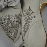Wedding dress, pale green silk crepe with silver satin, pont d’esprit, and lace, with matching gray shoes with steel-cut beads, 1907, detail of shoes