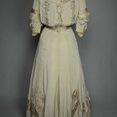 Wedding dress, pale green silk crepe with silver satin, pont d’esprit, and lace, with matching gray shoes with steel-cut beads, 1907, front view
