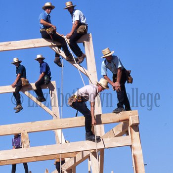 Amish men building barn