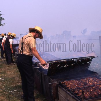 Amish men barbecuing chicken