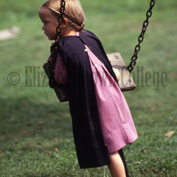 Amish girl on swing