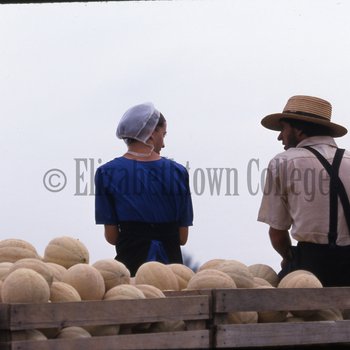 Amish man and woman with cantaloupes