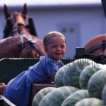 Smiling Amish girl with watermelons