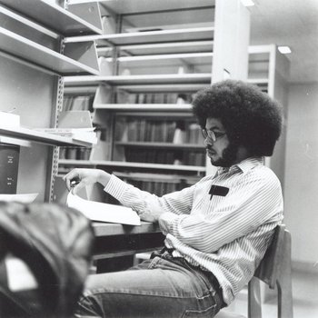 Johnnie Mask '76 studies in library.