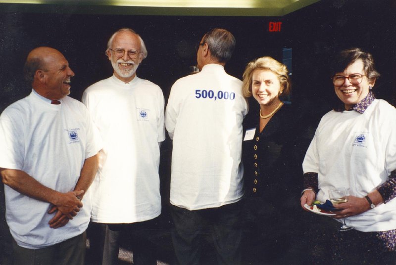 Rufty&#x27;s son, Richard Danner, Professor Andrew Kaufman, Dean Pamela Gann, and woman celebrate acquiring 500,000th book in the library collection.