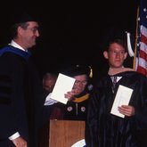 1992 Lynn Commencement: J. Murfree Butler presents the James J. Oussani Award to Gregory Dustin Reichman
