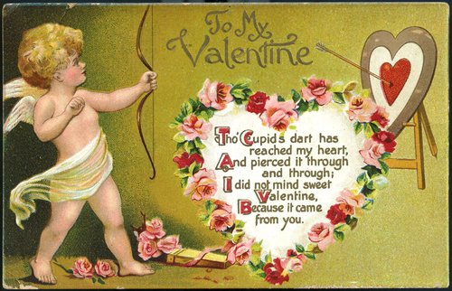Cupid has shot an arrow at a target on an easel. Text on a heart surrounded by roses: Tho&#x27; Cupid&#x27;s dart has reached my heart, and pierced it through and through. I did not mind, sweet Valentine, because it came from you.