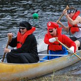 Founders Day 2010: Students in costume paddle to shore