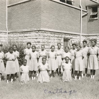Group Photo of 16 Adolescent School Girls outside Chapel