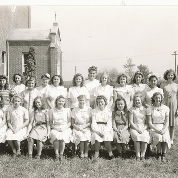 Group Photo of 21 Girls and Women outside Chapel