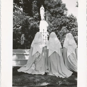 Veiled Women Kneeling at Grotto