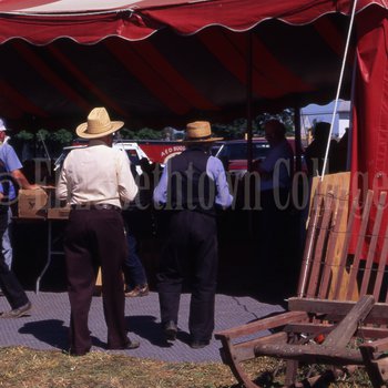 Amish men walking into tent
