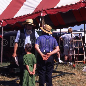 Two Amish men and young girl at mud sale