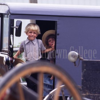 Amish boys looking out of buggy