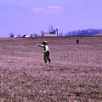 Amish boy flying kite