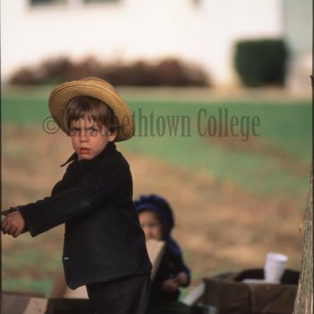 Amish boy looking towards camera