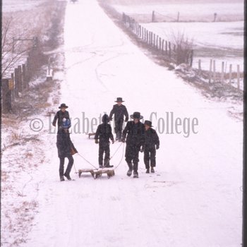 Amish children walk down road in snow