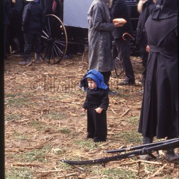 Amish child stands in crowd
