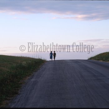 Amish girls walk in distance