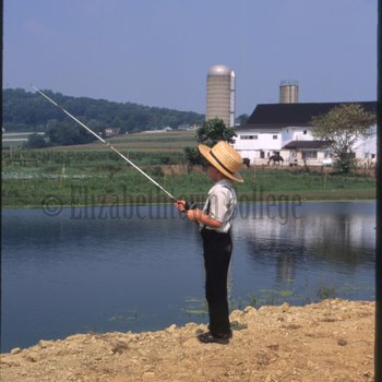 Boy fishing in pond