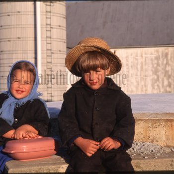 Children sitting on concrete