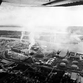 Pollution rising from smoke stacks at a cement plant, view 2