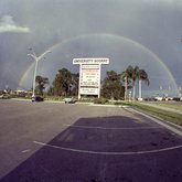 Rainbow over University Mall sign