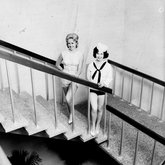 Two contestants posing on stairwell