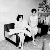 Two contestants seated on couch