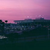 Parking garage and terminal at Tampa International Airport against a pink sky