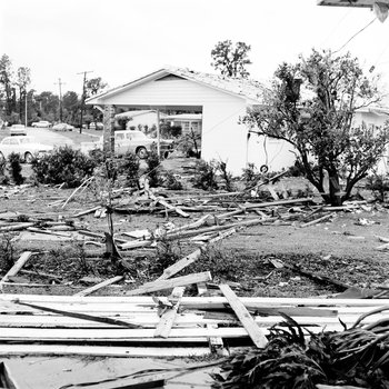 Home  and fence damaged from tornado