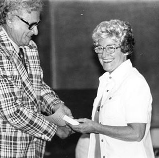 Chancellor Grobman Presenting Award to Creative Aging Volunteer Margaret Clayton. C. Late 1970s-1980s 709