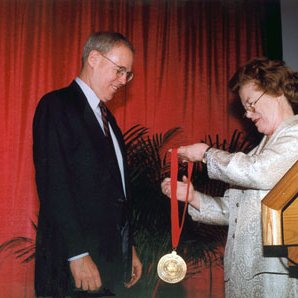 Chancellor's Report to Community, 1998, Chancellor Touhill Presenting Medallion to Senator Wayne Goode 4717