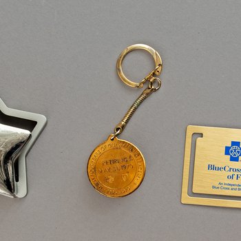 United Way Leadership Circle star-shaped card holder, Key Chain “Honoring Hilary A. Schroder, CEO,” 1970, “A Retirement Tribute To William E. Flaherty” bookmark, 1998