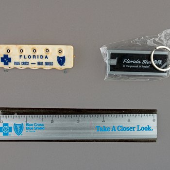 Florida Blue in the pursuit of health lighted key chain, undated; Florida Blue Cross – Blue Shield of Florida manual counter, undated; Blue Cross and Blue Shield of Florida "Take A- Closer Look" six inch ruler with plastic case, date unknown, 2 copies