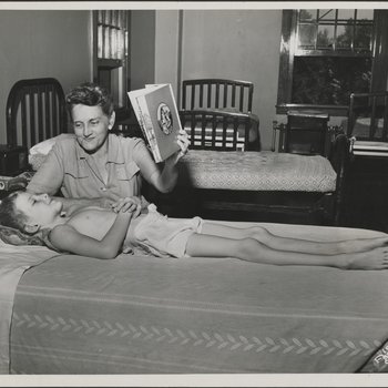 Principal of Hospital School Reads with Student Patient
