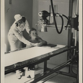 Nurse Positioning Young Patient's Arm for X-ray