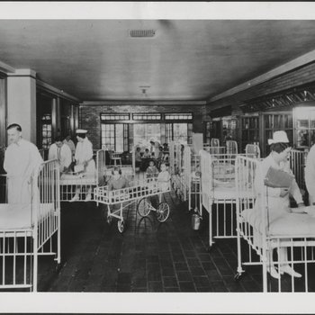 Nurses and Doctors Attending Patients in Hospital Ward