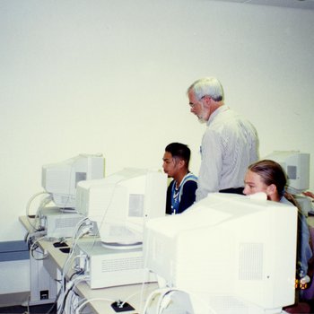 Professor Working With Students in Computer Lab