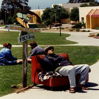 Student Resting on Chair Next to Signs